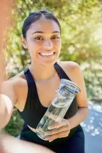 female staying hydrated - managing withdrawal nausea